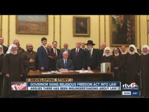 Indiana's Gov. Mike Pence signs this (unnecessary) law in ... private? Who invited the Mel Brooks movie extras?